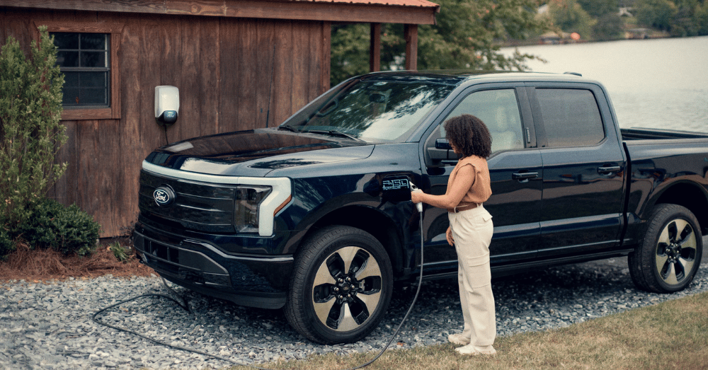 Ford's $30k Electric Truck Could Shake Up the EV Game - woman charging her Ford F-150 Lightning